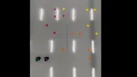 A robot coordinating with another robot to pick up different color objects.